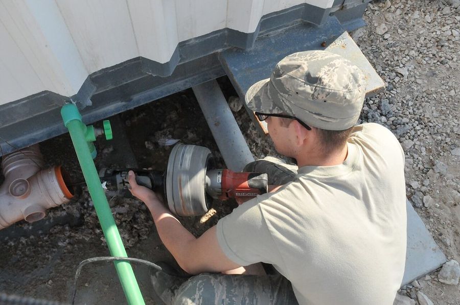 Clearing a drain line with a power auger